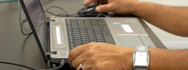 Fotografía: primer plano de manos  de persona que esta usando un computador